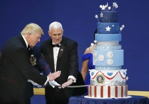U.S. President Donald Trump and Vice President Mike Pence prepare to cut a cake with a sword at the "Salute to Our Armed Forces" inaugural ball during inauguration festivities in Washington